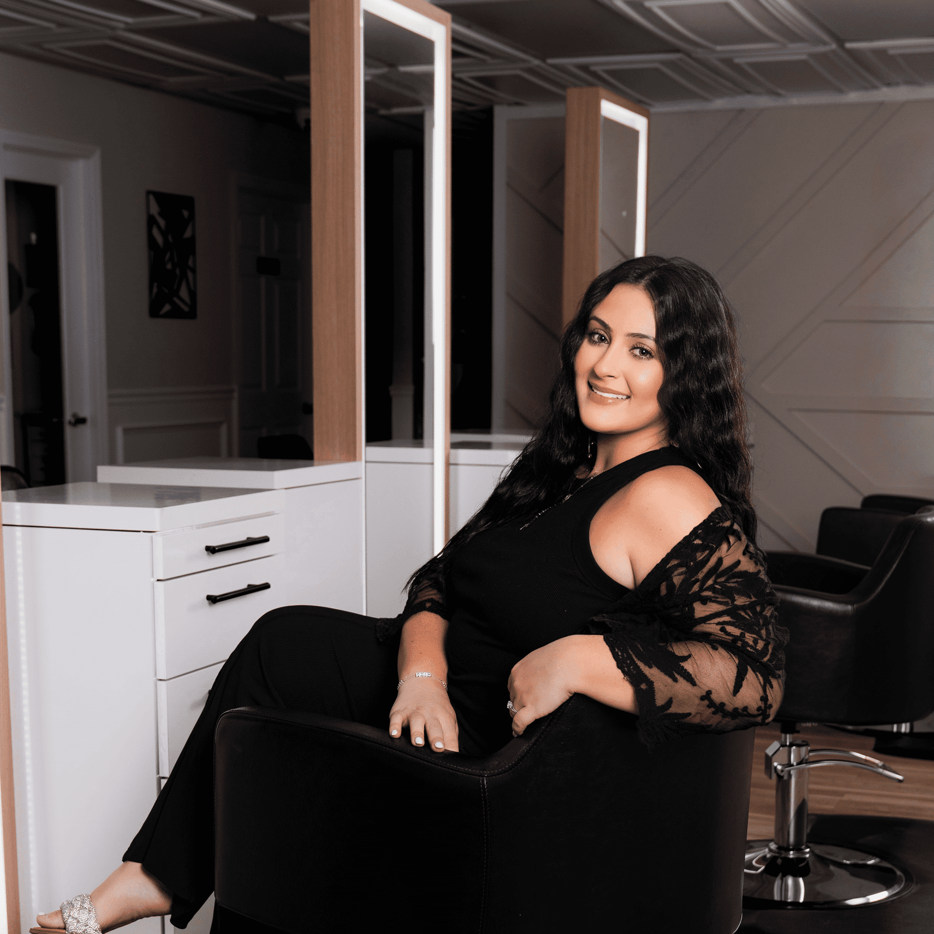 Portrait of Dina, a professional stylist at The Beauty Vault Hair Salon, showcasing their expertise and style.
